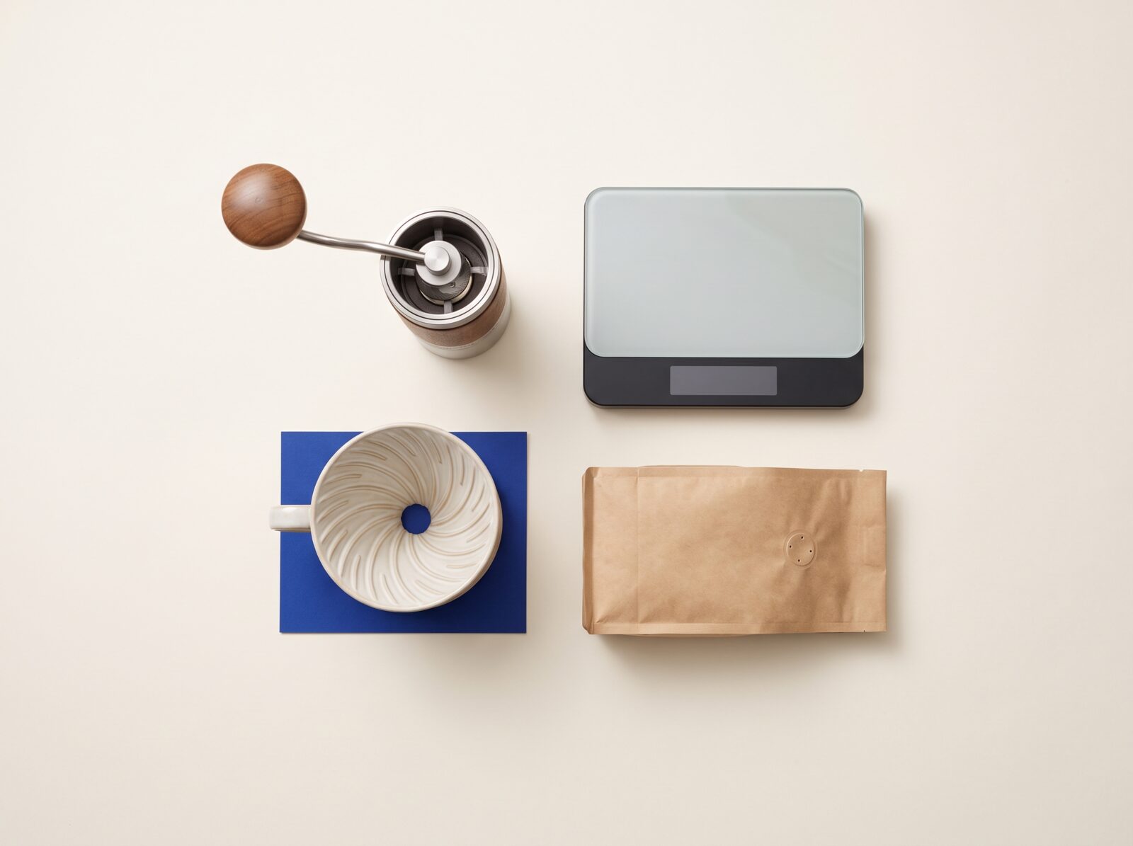 Four pieces of home coffee gear arranged on a counter